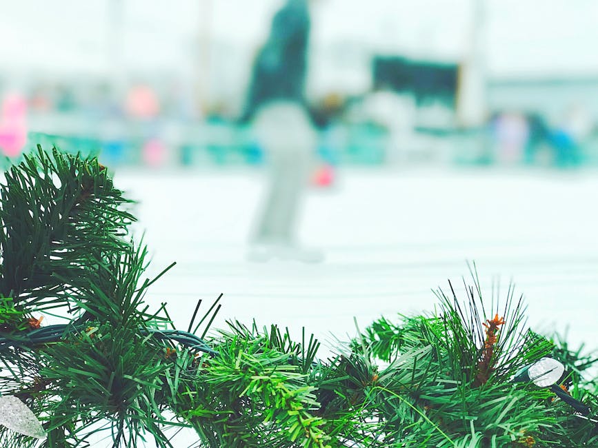 A cheerful winter scene featuring a vibrant green Christmas garland outdoors near an ice skating rink.