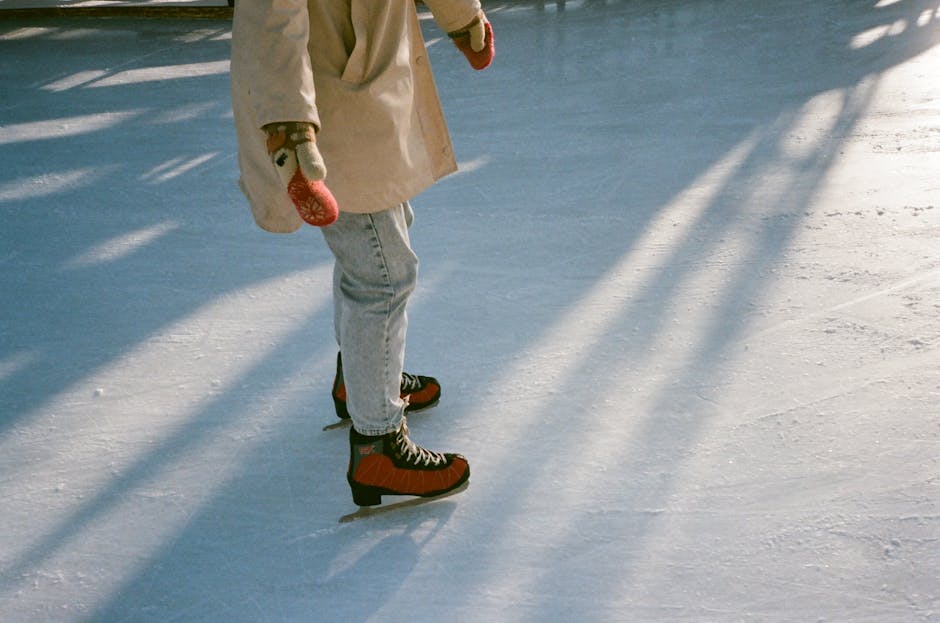 A woman gracefully ice skating outdoors on a sunny winter day.